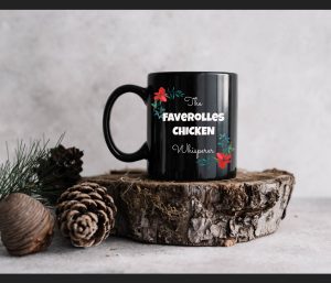 Black mug on a piece of log - the words faverolles whisperer and some flowers on the mug.