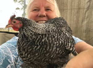 Me smiling broadly as I hold a Cuckoo Maran chicken close to her.