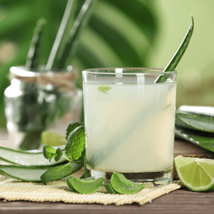 A refreshing glass of aloe vera water with fresh aloe vera leaves and mint, perfect for chickens.